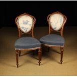 A Pair of Victorian Carved Walnut Medallion-back Chairs.