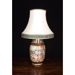 A Famille Vert Style Pot Lamp: The baluster vase enamelled with a battle scene and having an