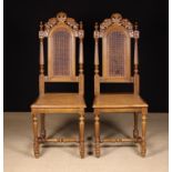 A Pair of 19th Century Carved Walnut Chairs with caned dome-topped backs and seats.