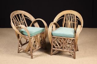 A Pair of Conservatory Wicker Armchairs with bent-wood hoop backs and arms,