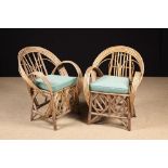 A Pair of Conservatory Wicker Armchairs with bent-wood hoop backs and arms,