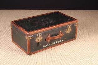 A Green Vintage Army Major's Suit Case with leather banded borders edged with brass headed pins,