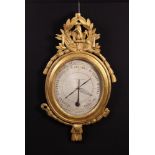 A Late 18th Century French Barometer in carved giltwood frame.