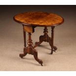 A Small Victorian Figured Walnut Sutherland Table inlaid with scrolling foliate embellishments and
