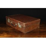 A Vintage Crocodile Skin Leather Overnight Case with silvered catches stamped JH JOHNSON & Co.