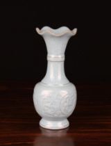 A Small Blue Crackle Glazed Baluster Vase moulded with flowers and having a crimped outswept rim,
