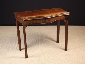 A George III Mahogany Serpentine Flip-top Card Table, with green baize playing surface.