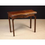 A George III Mahogany Serpentine Flip-top Card Table, with green baize playing surface.