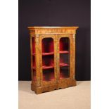 A Glazed Victorian Style Figured Walnut Display Cabinet inlaid with diagonally grained borders and