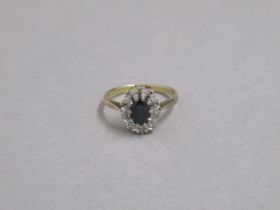 An 18ct yellow gold hallmarked sapphire and diamond cluster ring, size P, approx 3.9 grams