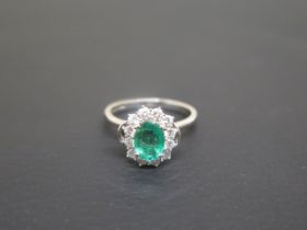 A good emerald and diamond cluster ring - The oval central stone approx 1.5ct and surrounded by 12