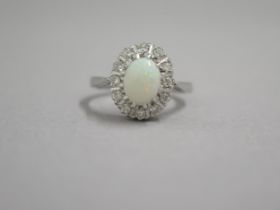 An 18ct white gold opal and diamond ring - head size approx 13mm x 11mm - ring size approx M