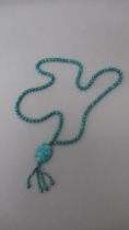 A string of natural turquoise beads with a drop pendant - beads approx 8mm diameter x 86cm long,
