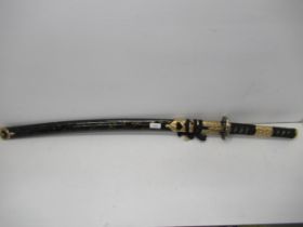 A modern Japanese Katana sword, edged blade approx 70cm with black and gold lacquered gilt metal