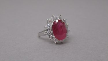 A certificated 18ct white gold large oval ruby and diamond cluster ring - Ruby 3.71ct - round