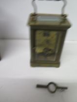 A brass cased four glass carriage clock in leather travelling case - approx 11cm - working in
