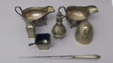 Silver items inc: A pair of sauce boats, Chester 1928, salt with spoon, pepper shaker, sugar shaker