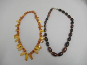 A dark amber graduated bead necklace approx 63cm long, approx weight 69 grams, with a Baltic amber