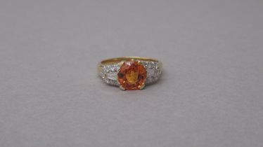 A certificated 18ct yellow gold ring set with round mixed cut natural fancy orange sapphire and