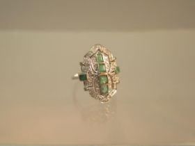 An Art Deco emerald and diamond ring set in platinum (tested) ring size M