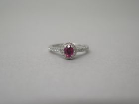 A platinum ruby and diamond ring - diamonds well matched, bright and lively - head size approx 8mm x