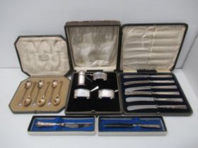 A boxed silver condiment set together with a boxed set of six teaspoons and a boxed set of six