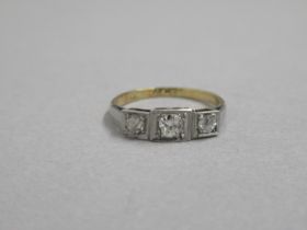 An 18ct yellow gold hallmarked and platinum three stone diamond ring, size K, approx 1.2 grams