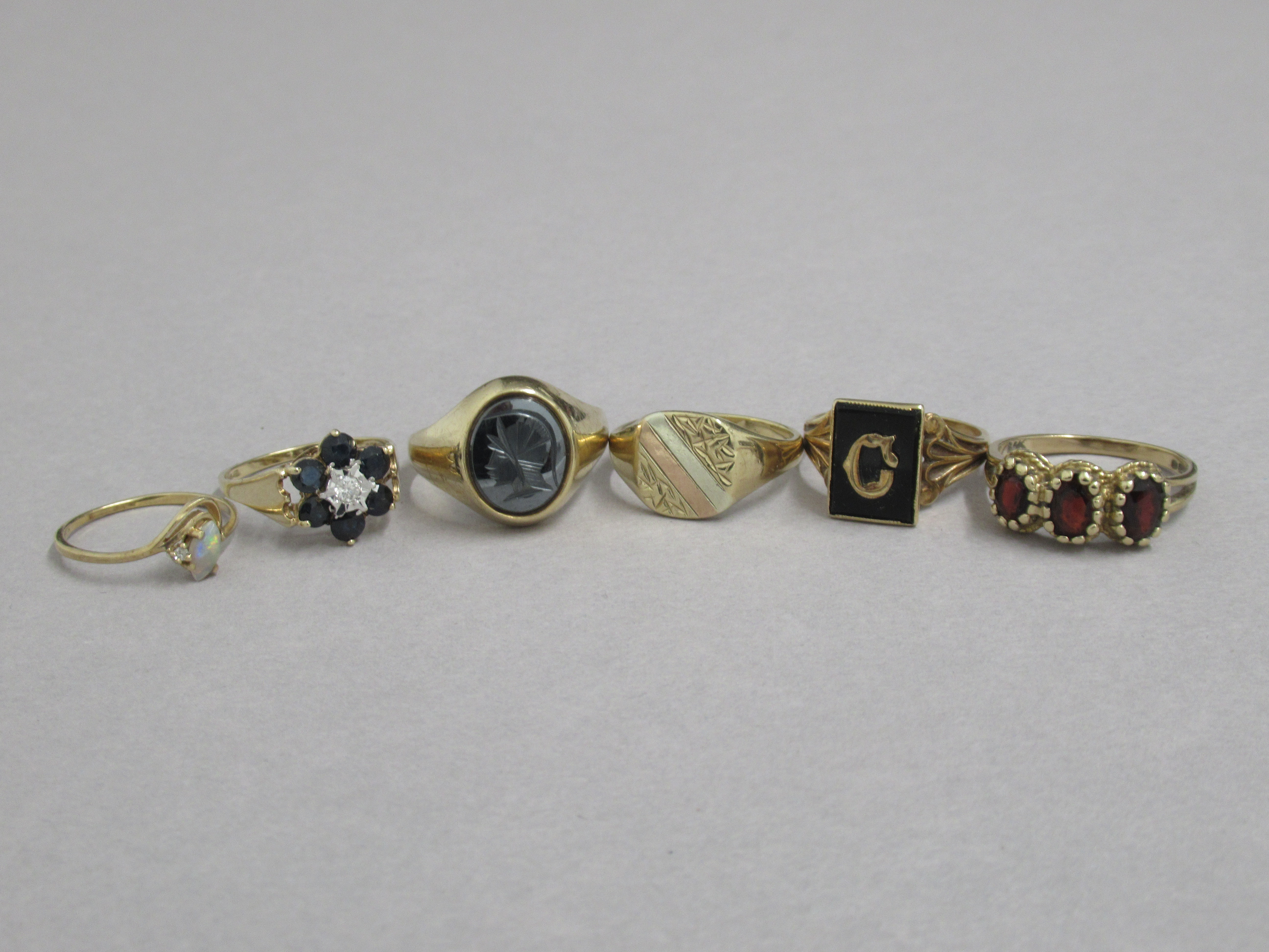 Six 9ct hallmarked rings, various sizes including opal and garnets
