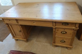 A Continental pine desk with cupboards and drawers - Width 143cm x Depth 77cm x Height 74cm