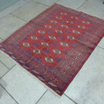 A Turkman hand knotted woollen rug - 1.66m x 1.30m