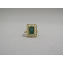 A very good 18ct yellow gold (hallmarked) emerald and diamond ring - the rectangular step cut