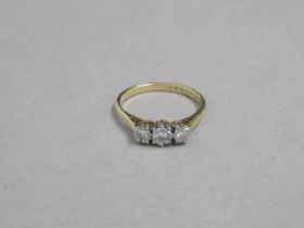 An 18ct yellow gold and platinum hallmarked 3 stone diamond ring, size O, approx 2.9 grams