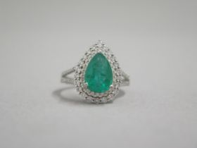 A stunning 18ct white gold (hallmarked) emerald and diamond ring, the central pear shaped emerald