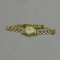 A ladies 18ct yellow gold cased (hallmarked) Nivada bracelet watch - round case approx 16cm with 9ct