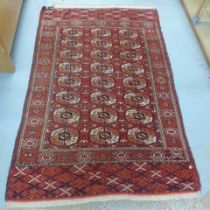 A hand woven woollen rug - 210cm x 127cm