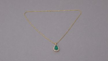 A certificated 18ct yellow gold pendant set with pear-cut emerald surrounded by a halo of round