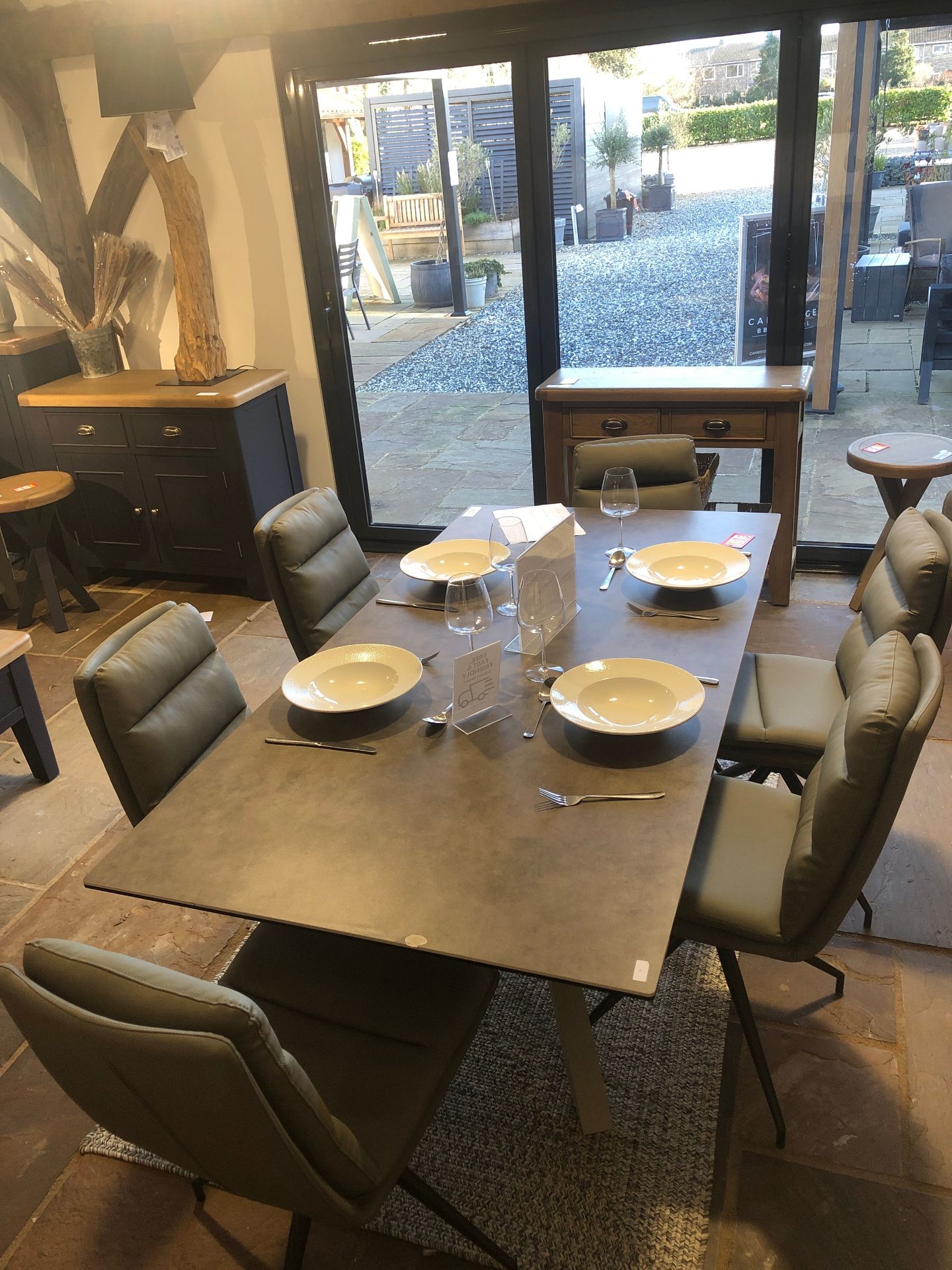 Italian bizzotto designed ceramic table with 6 nobo swivel dining chairs. Chip in table. Ex display