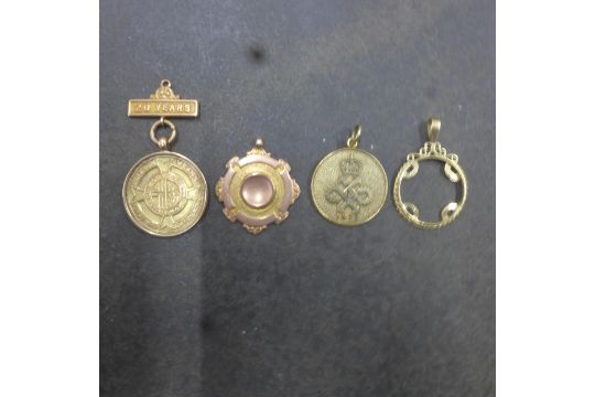 Four 9ct (hallmarked) medals/pendants - approx weight 23 grams