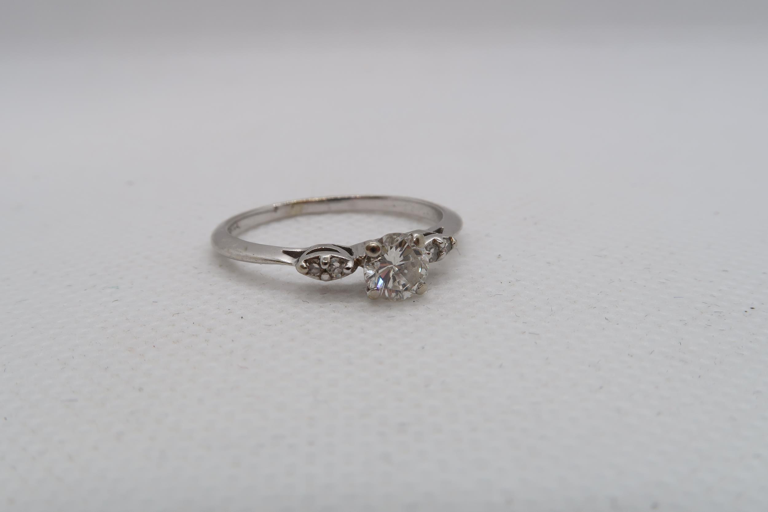 A 14ct white gold diamond ring with diamond shoulders - centre diamond approx 0.5ct - diamonds are