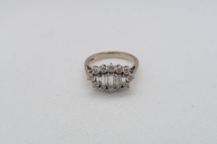 A striking round baguette and round brilliant cut diamond cluster ring - The five central