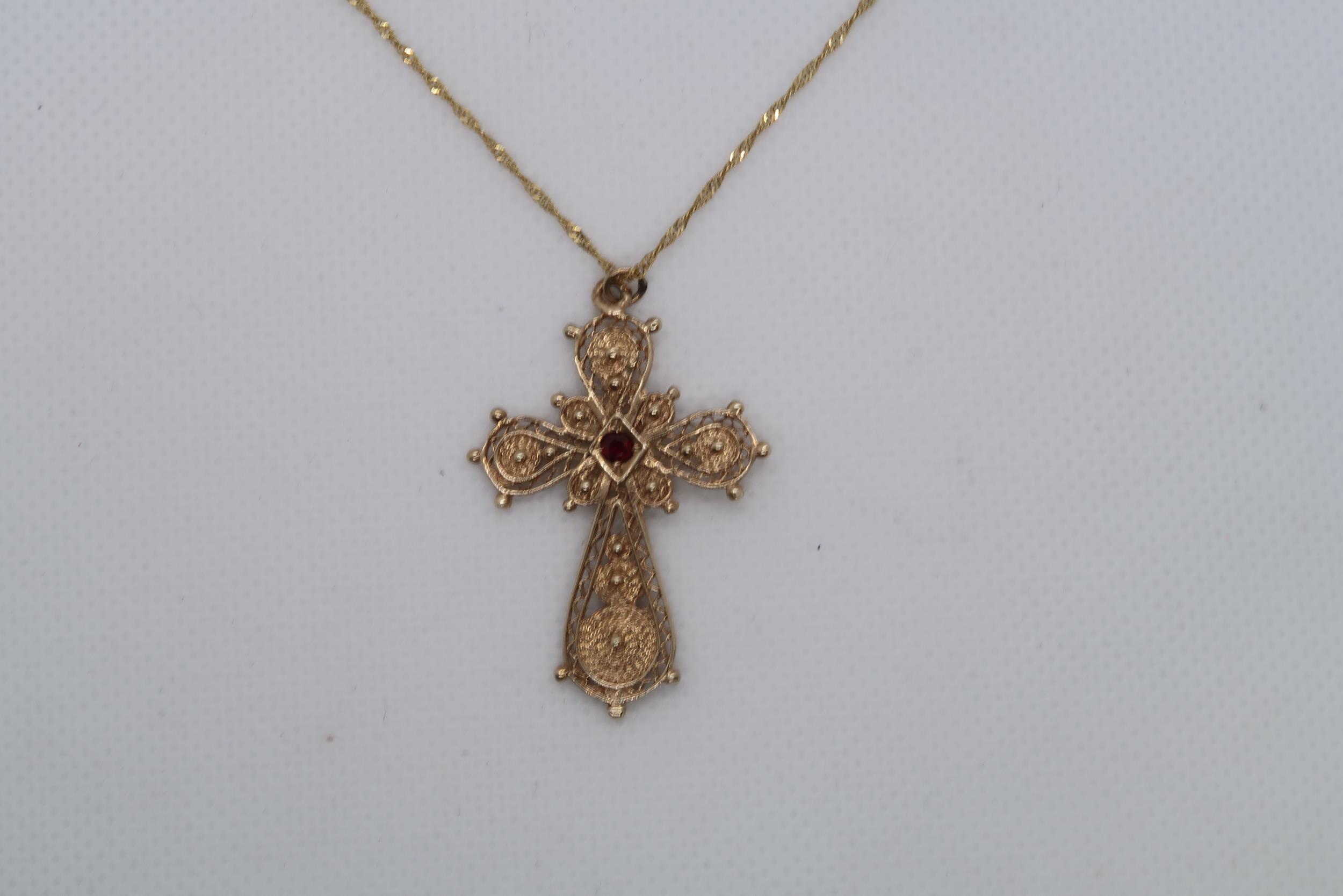 A 9ct yellow gold (hallmarked) filigree cross pendant with red garnet - approx 3.5cm - on a 9ct