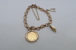 A 9ct yellow gold (hallmarked) bracelet with two charms and a mounted 1895 half sovereign - total