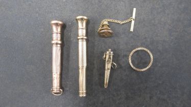 Two 9ct (hallmarked) cigar piercers, 6.5cm and 5.5cm, together with a 9ct gold (tested) conical