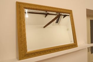 A modern gilt framed mirror with bevelled glass - 93cm x 67cm