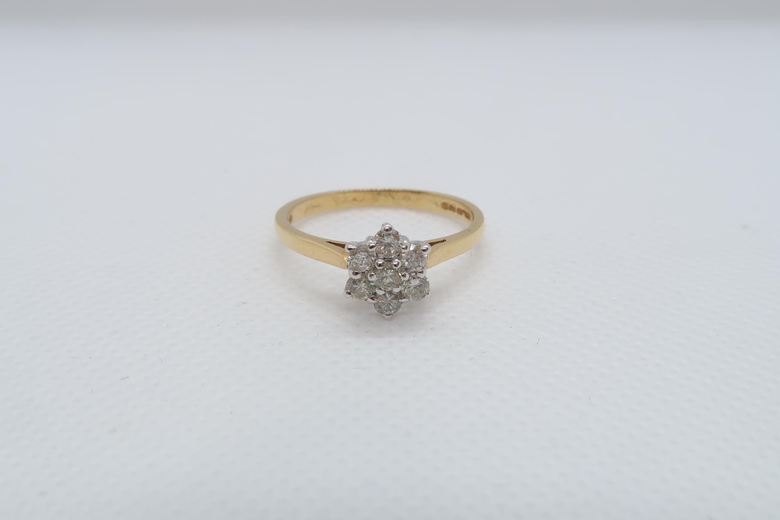 An 18ct yellow gold (hallmarked) and diamond daisy cluster ring size V - approx weight 3.7 grams