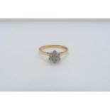 An 18ct yellow gold (hallmarked) and diamond daisy cluster ring size V - approx weight 3.7 grams