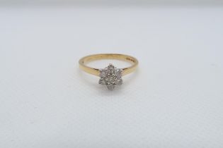 An 18ct yellow gold (hallmarked) and diamond daisy cluster ring size V - approx weight 3.7 grams