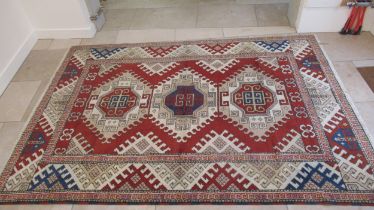 A large hand knotted wool rug - 295cm x 208cm