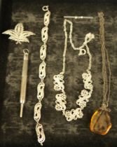 Three pieces of silver filigree jewellery, an Amber pendant on silver chain, a silver pencil and a