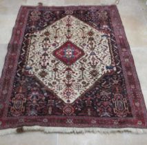 A Persian Qashqai red ground rug - approx 195cm x 155cm